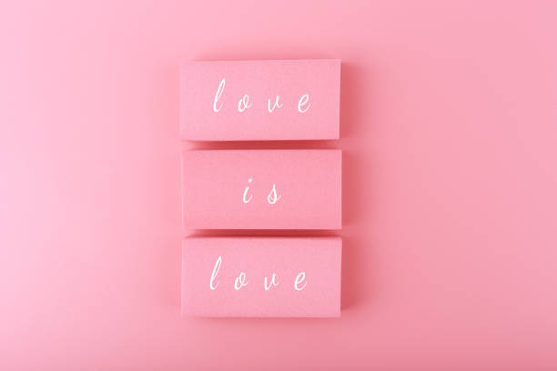 istock Love is love written on pink blocks with bright pink background 1326581549