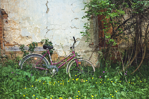 Old bike in front of abandoned house