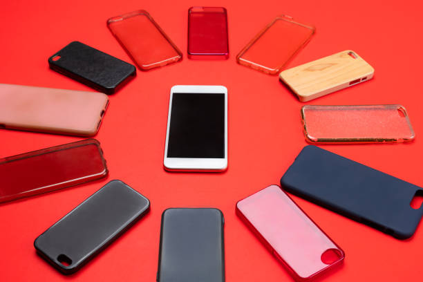 istock Choice of multicolored plastic back covers for mobile phones on red background with a smart phone on the side 1326583232