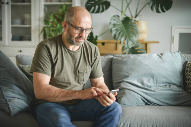 istock mature adult man working from home office (smart phone) 1326585246