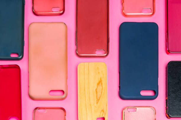 istock Pile of multicolored plastic back covers for mobile phone. Choice of smart phone protector accessories on pink background. A lot of silicone phone backs or skins next to each other 1326585474
