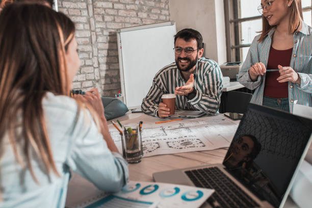 istock Group of young people discussing architectural designs in the creative office. 1326585497