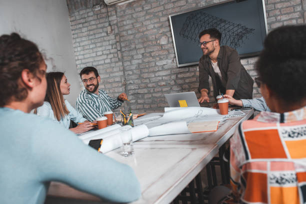 istock Group of young people discussing architectural designs in the creative office. 1326585522