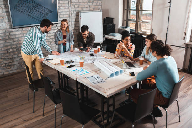 istock Group of young people discussing architectural designs in the creative office. 1326592598