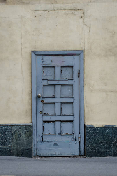 istock An old grey door with cracked paint 1326597283