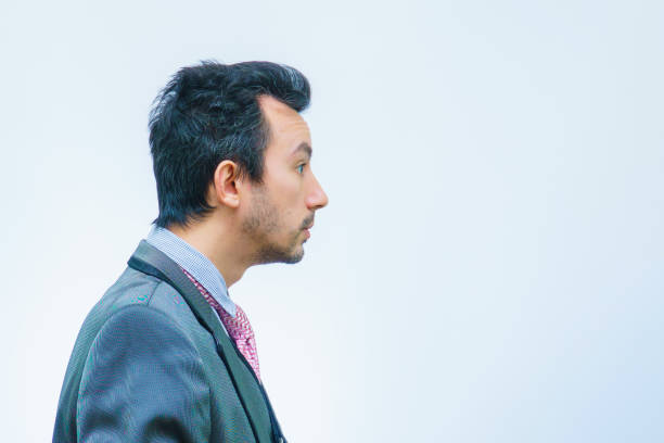 istock Funny unshaven man in suit with tie on gray background 1326605687