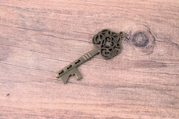 Photo of Old Key on rustic wooden texture background