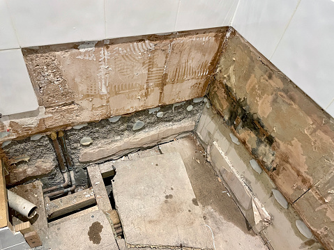Stock photo showing damp chipboard flooring due to leaking shower tray, As a result the shower tray was removed from the bathroom to be replaced by a bath and thermostatic shower.