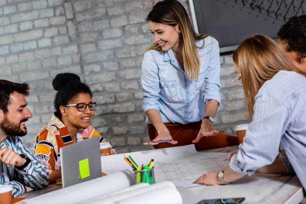 istock Group of young people discussing architectural designs in the creative office. 1326606939