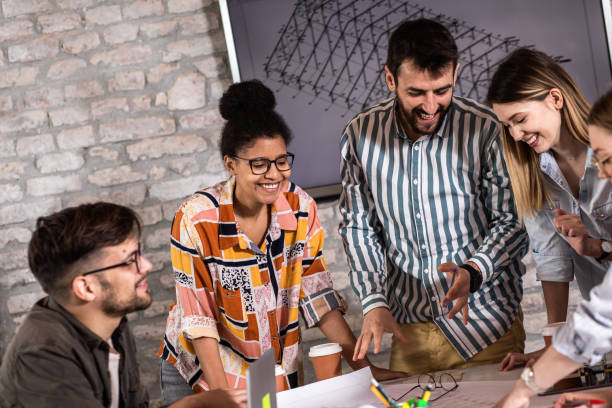istock Group of young people discussing architectural designs in the creative office. 1326607034