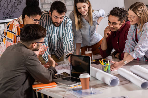 istock Group of young people discussing architectural designs in the creative office. 1326607094