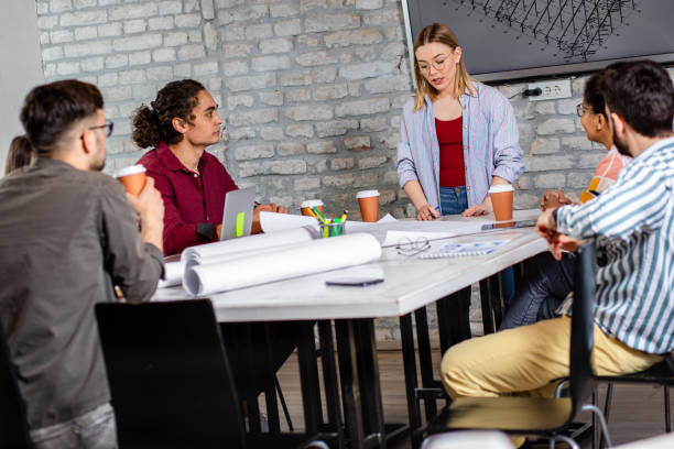 istock Group of young people discussing architectural designs in the creative office. 1326607184