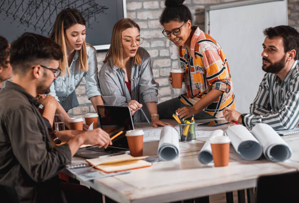 istock Group of young people discussing architectural designs in the creative office. 1326607240