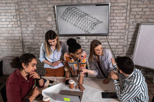 istock Group of young people discussing architectural designs in the creative office. 1326607539