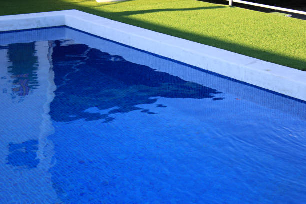 istock Edge of a pool with grass around it 1326607709