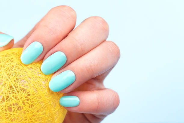 istock Hand with turquoise nails with ball 1326608487