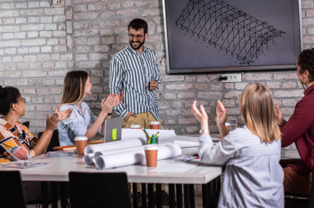 istock Group of young people discussing architectural designs in the creative office. 1326608534