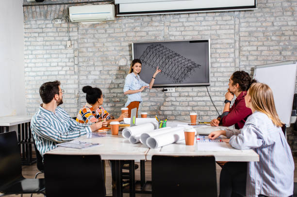 istock Group of young people discussing architectural designs in the creative office. 1326608652