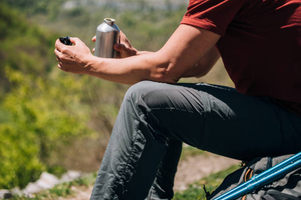 istock crop hiker sitting while resting with water bottle in rock 1326610991