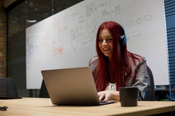 istock Young female programmer sitting in front of laptop. 1326611765