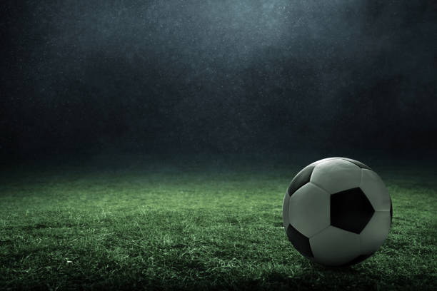 istock Soccer ball on green field 1326612359