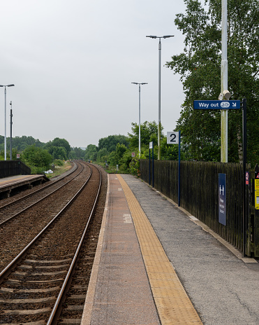 Platform at Aberdour Station, Fife, Scotland with the waiting room area and part of the station garden.