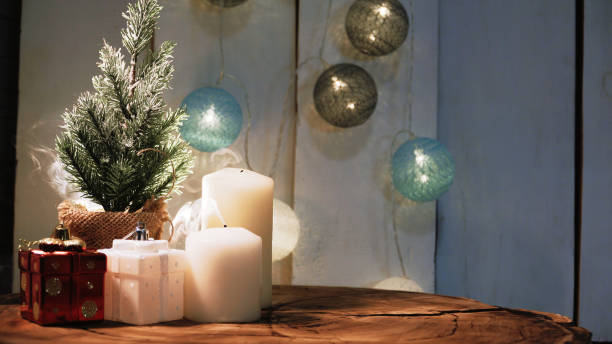 istock Small Christmas tree and candles on a wooden background 1326613257