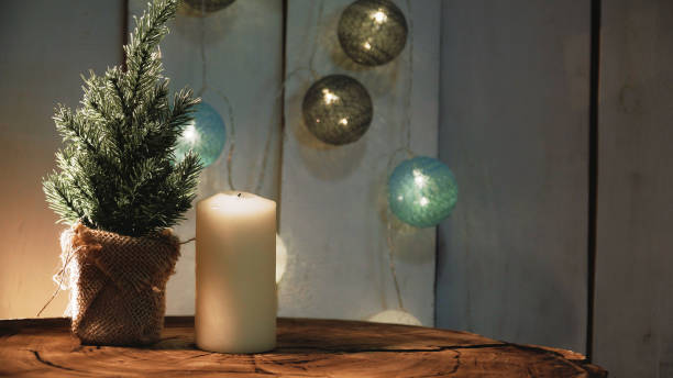 istock Small Christmas tree and candles on a wooden background 1326613285