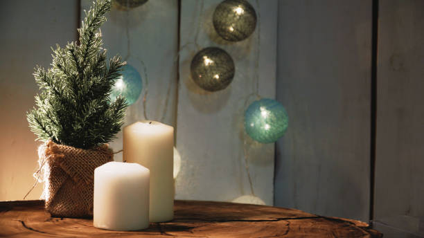 istock Small Christmas tree and candles on a wooden background 1326613325