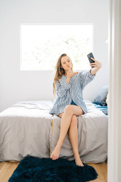 istock beautiful young female video calling on smart phone 1326613554