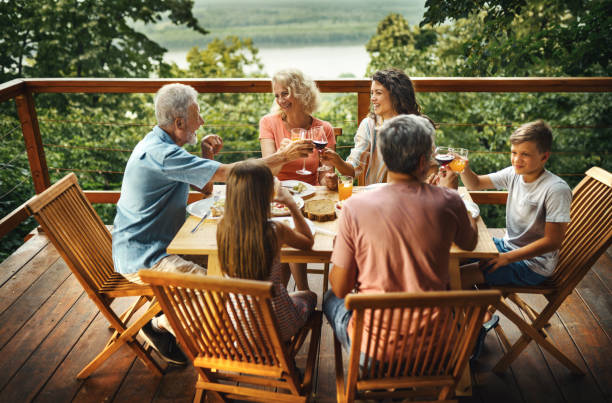 friends and family having a dinner party. - dining senior adult friendship mature adult imagens e fotografias de stock