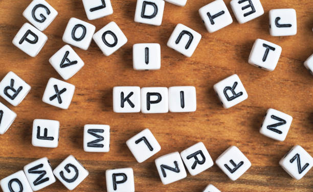 istock Small white and black bead cubes on wooden board, letters in middle spell KPI - Key Performance Indicators concept 1326615393