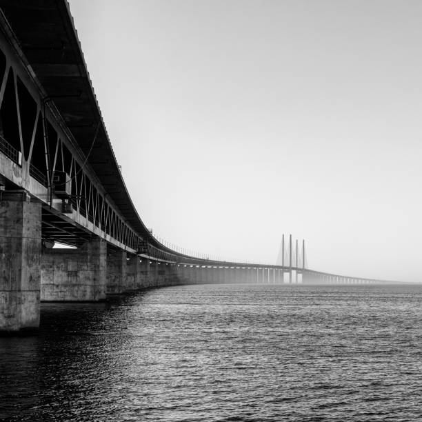 black and white view of the Oresund Bridge between Denmark and Sweden A black and white view of the Oresund Bridge between Denmark and Sweden oresund bridge stock pictures, royalty-free photos & images