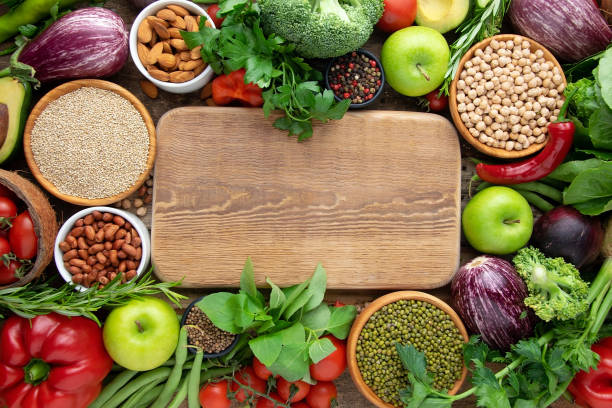 istock Fresh vegetables, cereals: mung bean, chickpeas, quinoa, nuts, kitchen wooden board for your text. 1326617703