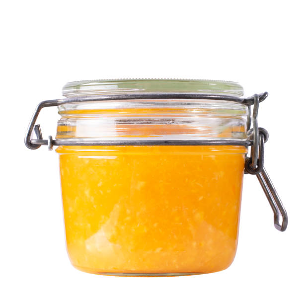 istock Orange jam in a jar on an isolated background. 1326617814
