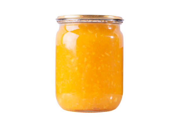 istock Orange marmalade jam in a jar on a white isolated background. 1326617824