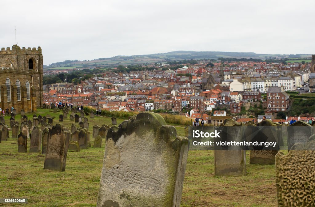 Old Tombstones in Whitby Colour photograph of an old graveyard in Whitby overlooking the town where Dracula is set in England England Stock Photo