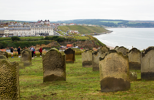 Colour photograph of an old graveyard in Whitby overlooking the town where Dracula is set in England