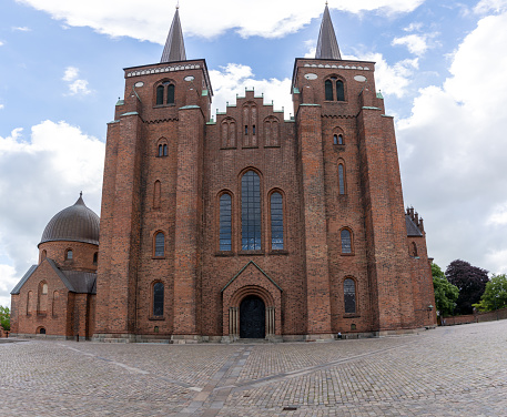 Roskilde, Denmark . 13 June, 2021: low angle view of the historic Lutheran Roskilde cathedral in the city center
