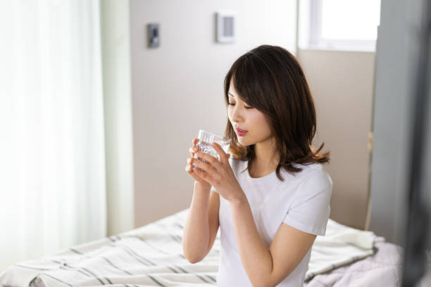 istock A young woman waking up and rehydrating 1326621022
