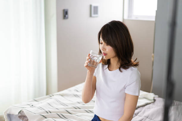 istock A young woman waking up and rehydrating 1326621026