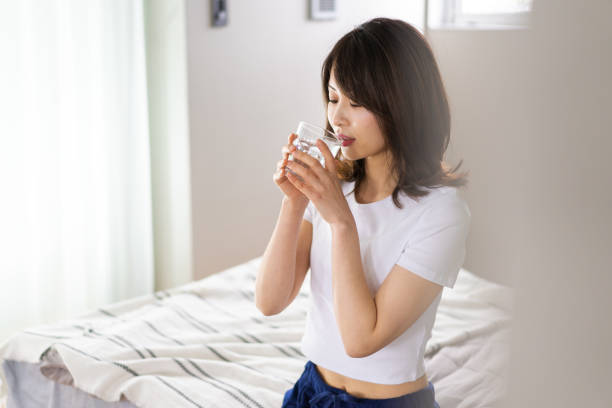 istock A young woman waking up and rehydrating 1326621029