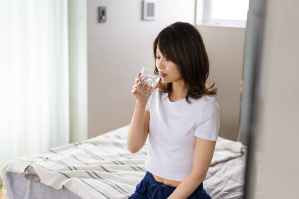 istock A young woman waking up and rehydrating 1326621030