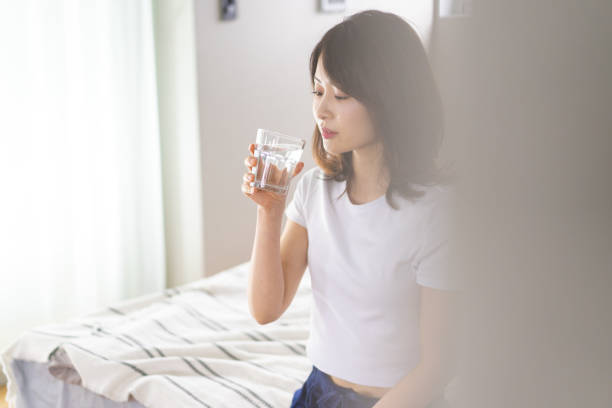 istock A young woman waking up and rehydrating 1326621032