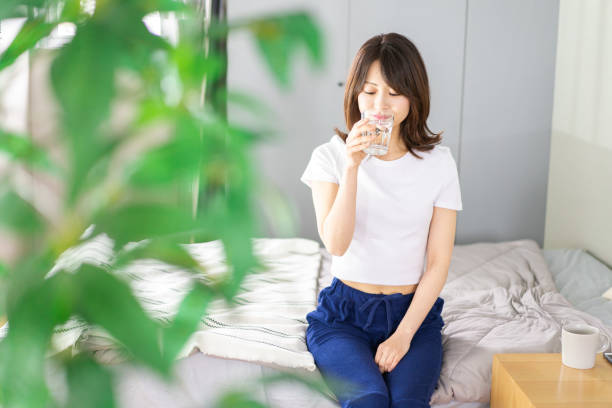 istock A young woman waking up and rehydrating 1326621071