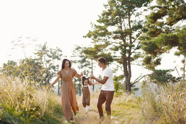 istock Cute family playing in a autumn field 1326623582