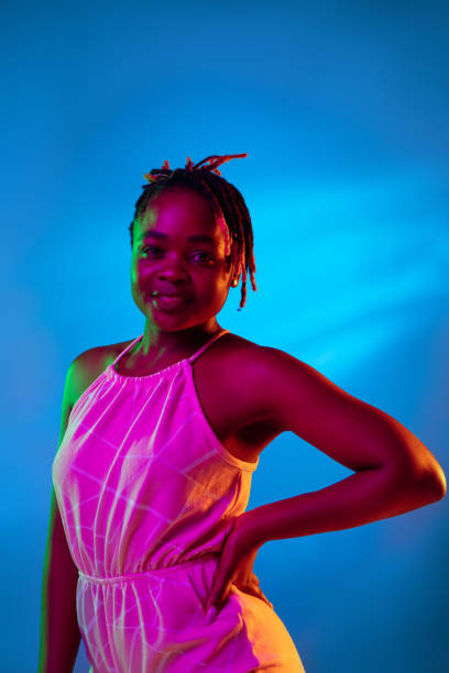 istock One young African beautiful girl isolated over blue studio background in mixed light. 1326625251