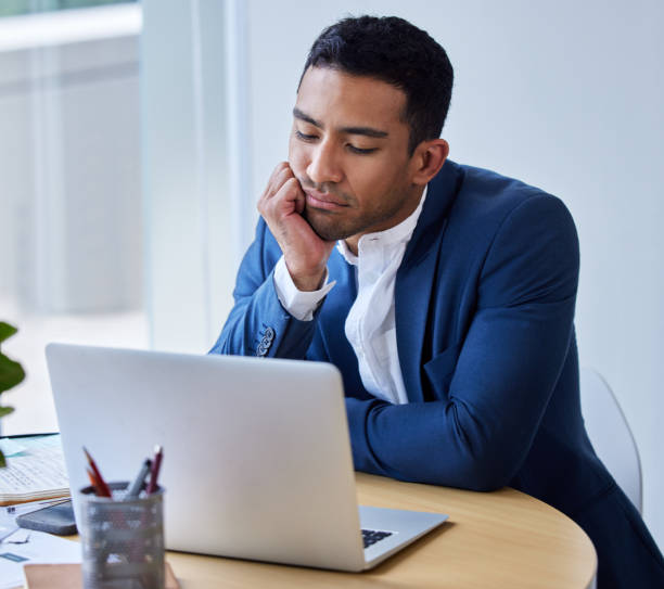 istock Shot of a young businessman looking bored at work 1326626761