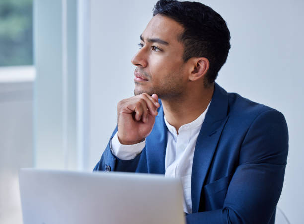 istock Shot of a young man taking a break to day dream at work 1326627295