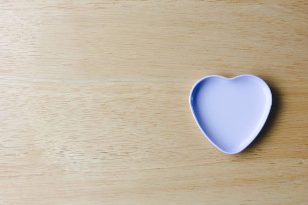 istock White heart on wooden background, copy space. 1326629425